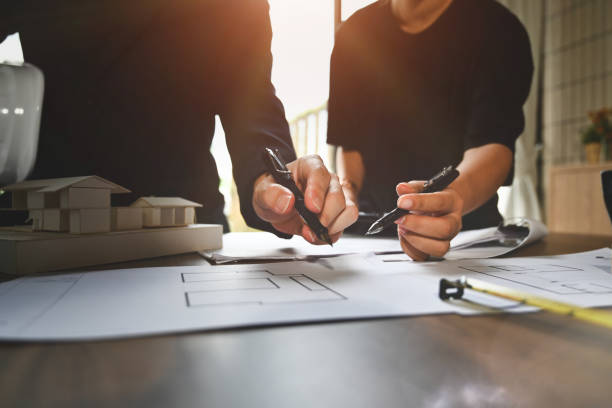 istock Architect team standing at meeting table and working on construction project of residential 1718267936