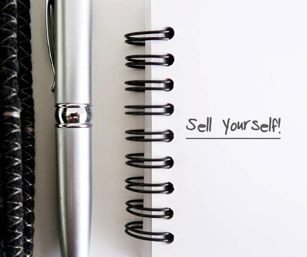 istock Professional black notebook , a pen and a blank notebook with text written SELL YOURSELF, concept self marketing in professional business world to get hiring or make money with or writing from customers 1718281912