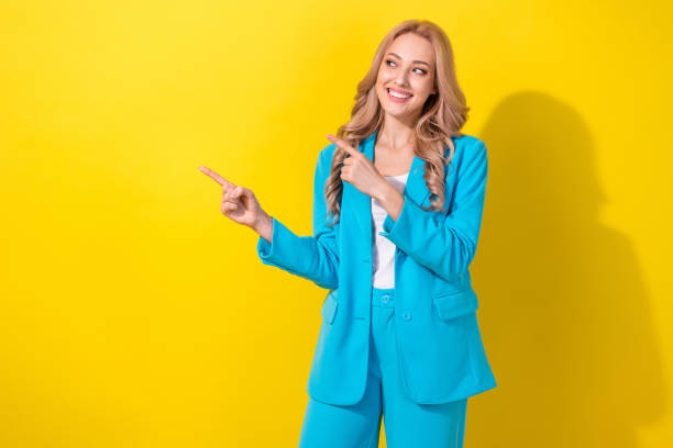 istock Portrait of nice cheerful lady look indicate fingers empty space proposition isolated on yellow color background 1718303554