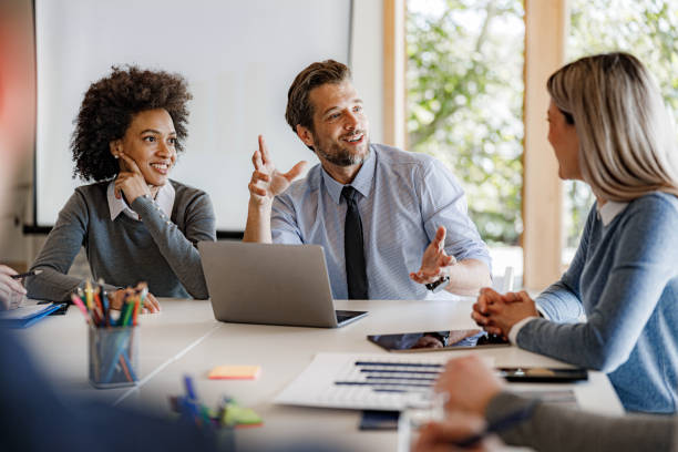istock Group of happy entrepreneurs having a discussion in the office. 1718305725