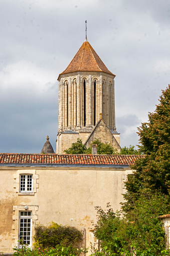Bell tower and side view of the 11th-century Romanesque church of Notre-Dame de Surgeres