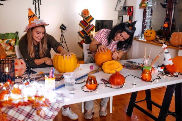 istock Two young woman having fun at home with preparing for Halloween night 1718330578