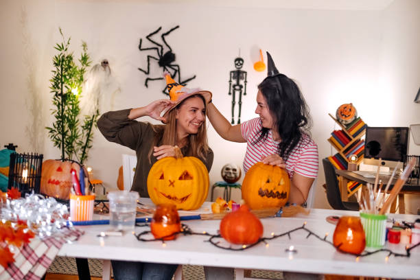 istock Two young woman having fun at home with preparing for Halloween night 1718330616