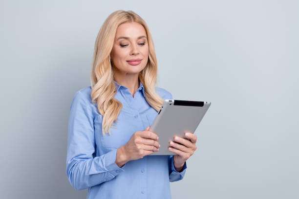 istock Portrait of pretty successful elegant lawyer use tablet communicate empty space ad isolated on grey color background 1718336064
