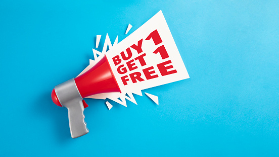 Buy one get one free text announcement with megaphone on blue background