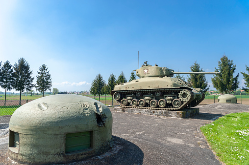 Hatten, France - May 05, 2022: Esch casemate hear Hatten as part of former Maginot Line. Here M4 Sherman tank between two machine gun turrets. Bas-Rhin department in the Alsace region of France