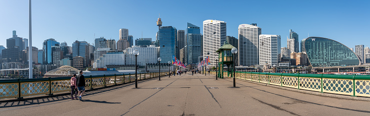 Sydney, Australia - July 25, 2023: Winter sun shines down on Pyrmont Bridge in Sydney, linking the attractions in Darling Harbour to the high-rise action in the CBD.