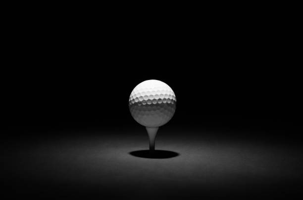 istock Golf Ball Spotlit on a Black and Gun-Metal Background 1718382122