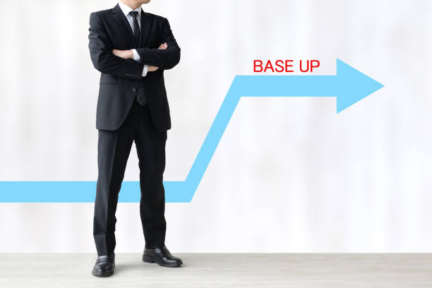 istock Thinking business man and upward arrow with BASE UP word 1718388252