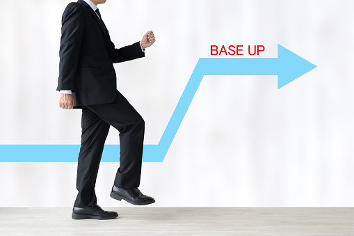 Business man stepping forward and upward arrow with BASE UP word
