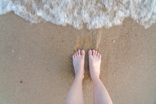 feet standing on the beach