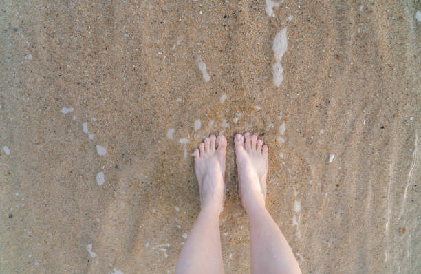 istock feet standing on the beach 1718390500