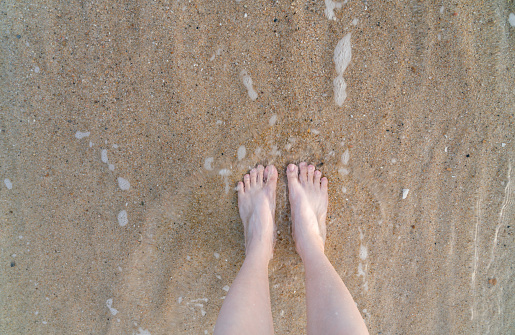 feet standing on the beach