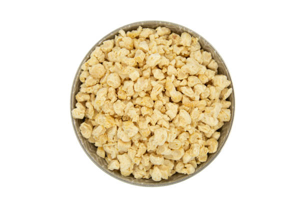 istock Raw dehydrated soy meat or soya textured chunks in a bowl isolated on white background. Top view 1718406936
