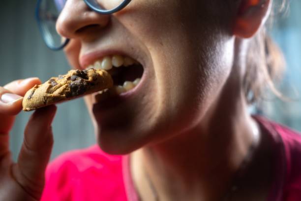 istock Female enjoying her favorite cookie at home 1718409170