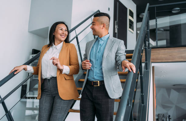 istock Business colleagues talking on stairs in the office. 1718414134