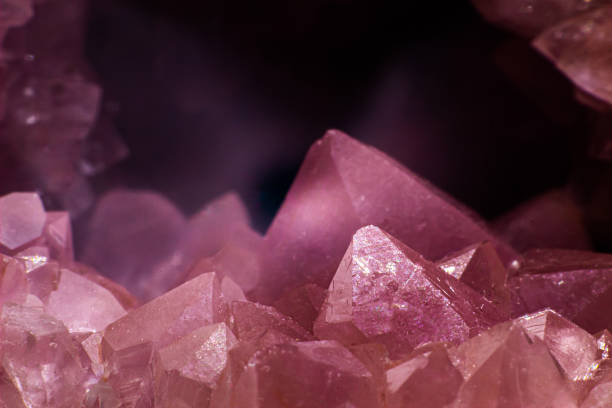 istock Macro focused vibrant pink amethyst quartz geode crystal, rose hematite amethyst points isolated 1718415793