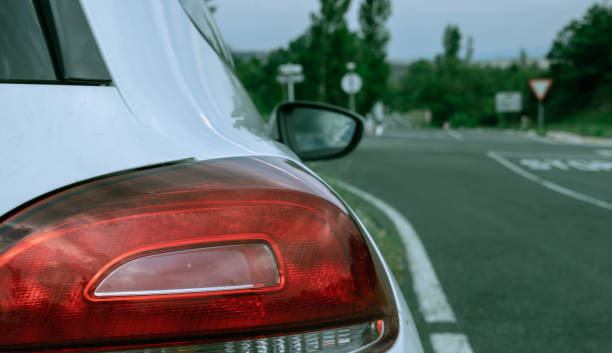 istock Car paused by the road, from behind 1718438911