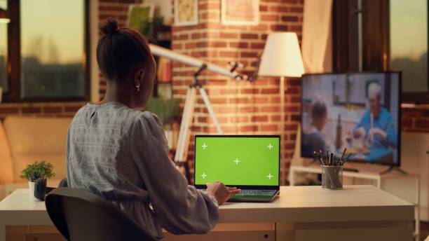 istock Woman looks at greenscreen on display 1718441646