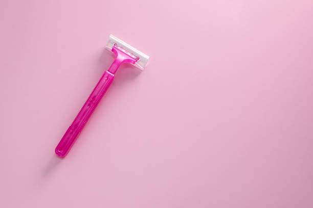 istock Disposable shaving razor for hair removal on pink background 1718444472