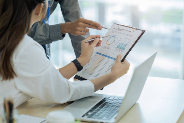 istock accountant team with laptop and paperwork analyzing financial data report 1718444481