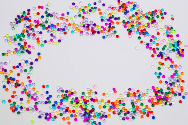 istock Multicolored tiny faceted crystals on a pink background, beautiful colorful texture 1718444486