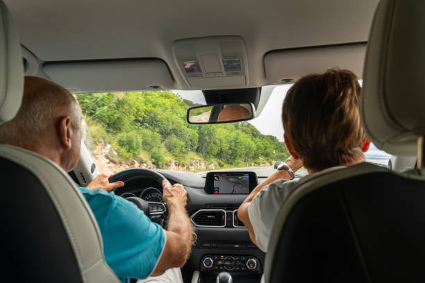 istock senior couple driving on road on summer vacation 1718447916