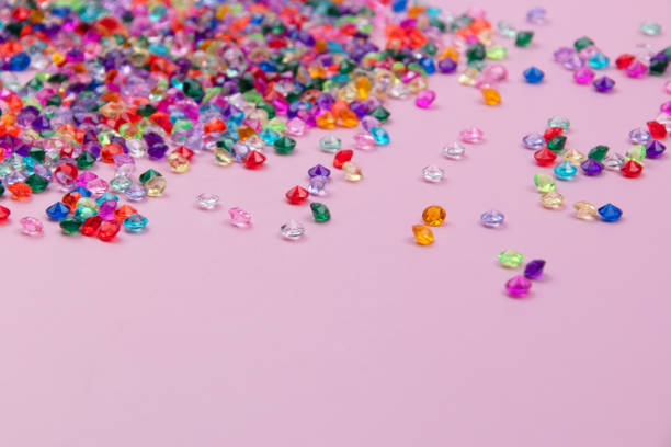 istock Multicolored tiny faceted crystals on a pink background, beautiful colorful texture 1718449058