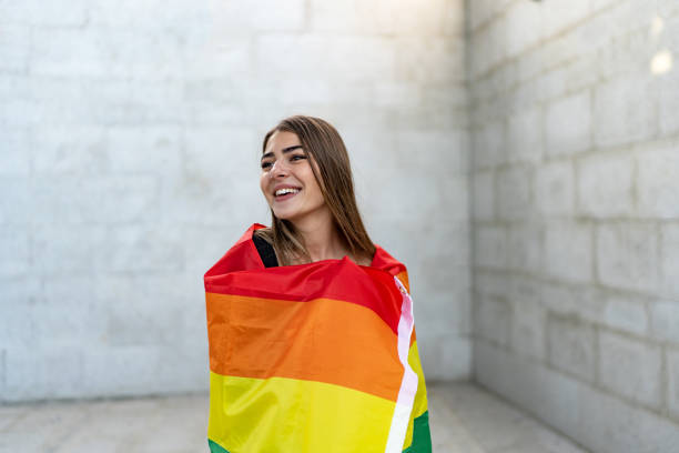 istock Confident young woman holding a rainbow flag 1718449616