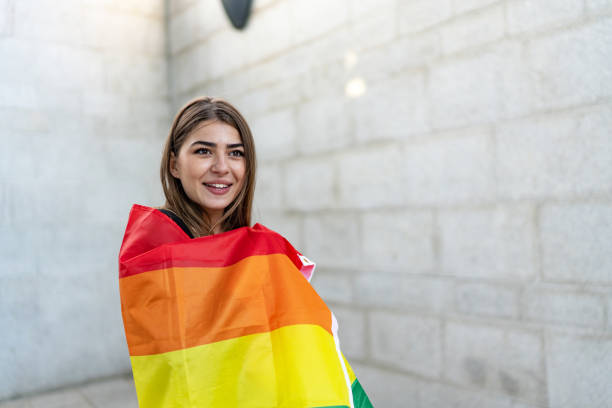 istock Confident young woman holding a rainbow flag 1718450725