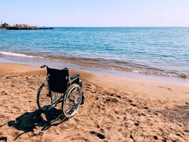 Wheelchair on the calm beach stock photo