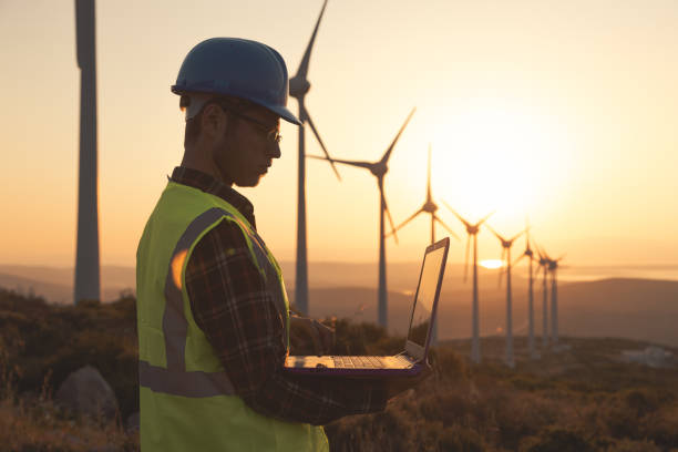 istock Renewable Energy Systems Innovator: Engineer Planning at Wind Turbines Farm 1718458037
