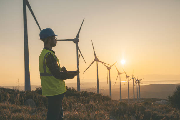 istock Renewable Energy Systems Innovator: Engineer Planning at Wind Turbines Farm 1718460797