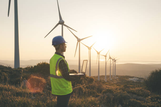 istock Renewable Energy Systems Innovator: Engineer Planning at Wind Turbines Farm 1718460798