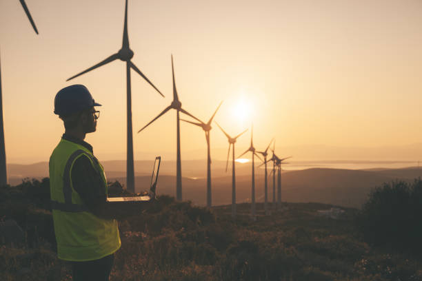 istock Renewable Energy Systems Innovator: Engineer Planning at Wind Turbines Farm 1718460801