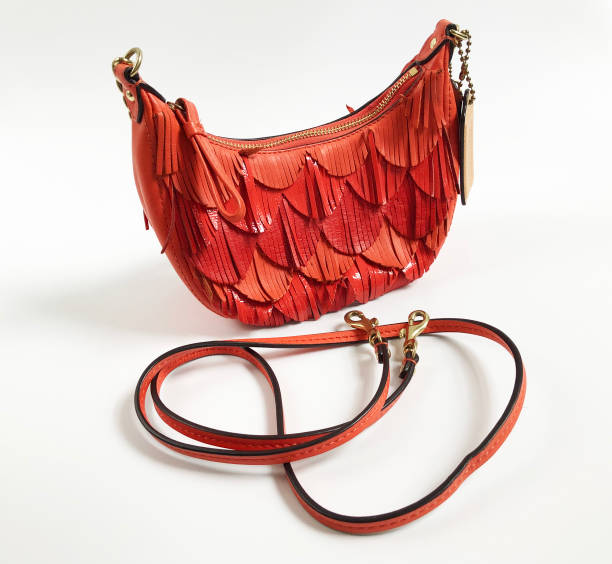 istock Vintage orange leather hobo bag on white background 1718471175