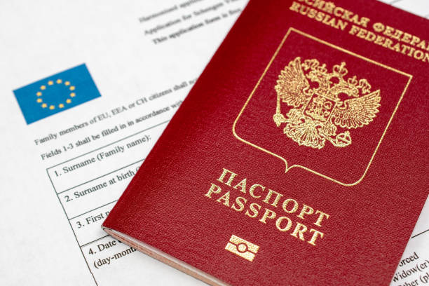 istock Russian travel passport with Schengen visa application form, sanctions, emigration, immigration, tourism concept 1718486397