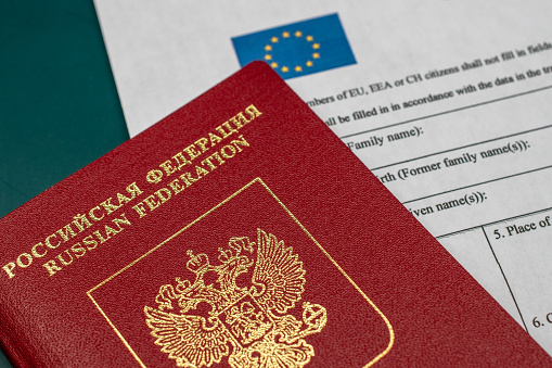 Ukrainian and Russian passports on the wood table