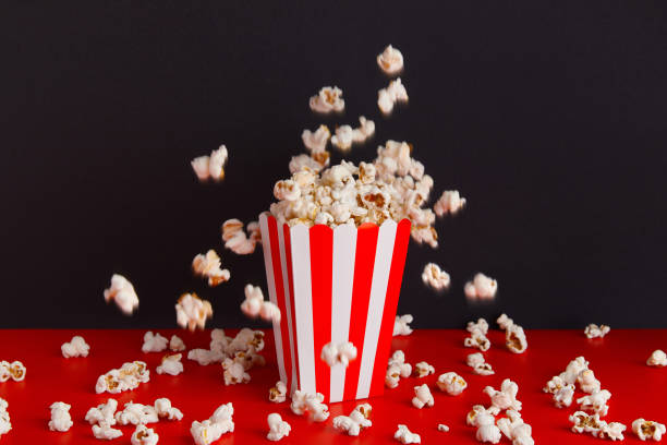 istock Striped box with popcorn on a red and black background 1718500097