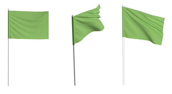 Green Flag waving in the wind on flagpole. Isolated flag