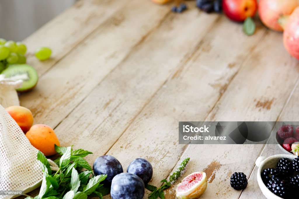 Variety of fruits on table with copy space Variety of fruits on table with copy space. Healthy organic fruits on wooden table. Antioxidant Stock Photo