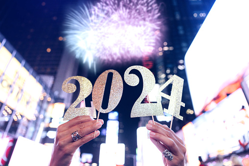 People hold the number 2024, celebration conceptual image for New Year’s Eve.