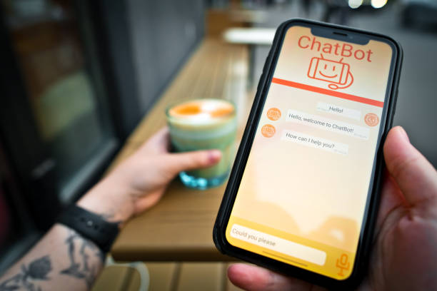 istock Young woman using AI Chatbot app on her smartphone outdoors in a cafe. Artificial Intelligence concept. 1718532597