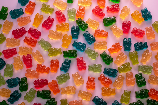 A vibrant assortment of gummy candies, featuring colorful jelly bears and various sweet treats.