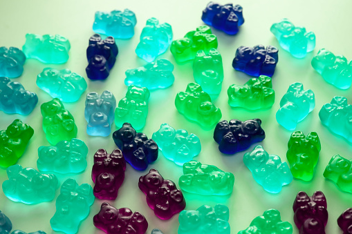 A vibrant assortment of gummy candies, featuring colorful jelly bears and various sweet treats.