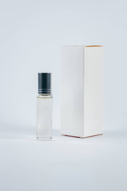 istock Glass bottle with perfume and with white cardboard box on white background 1718555673