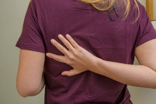 Pain in the shoulder blade, the woman holds her back on one side Pain in the shoulder blade, the woman holds her back on one side closeup scapula stock pictures, royalty-free photos & images