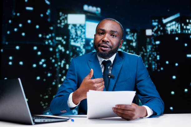 Man reporter reading daily headlines in newsroom, presenting important information regarding public interest during night show segment. Media journalist collecting details to debate on tv channel.