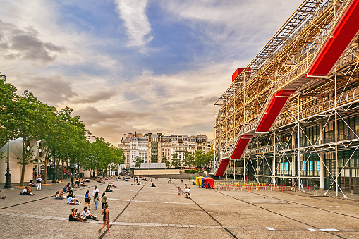 Paris, France - July 11, 2023: Pedestrians on the Place Georges Pompidou in front of  the Center Pompidou in the evening.