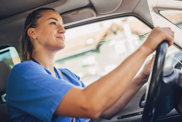 istock Female nurse driving car and going to work 1718595184